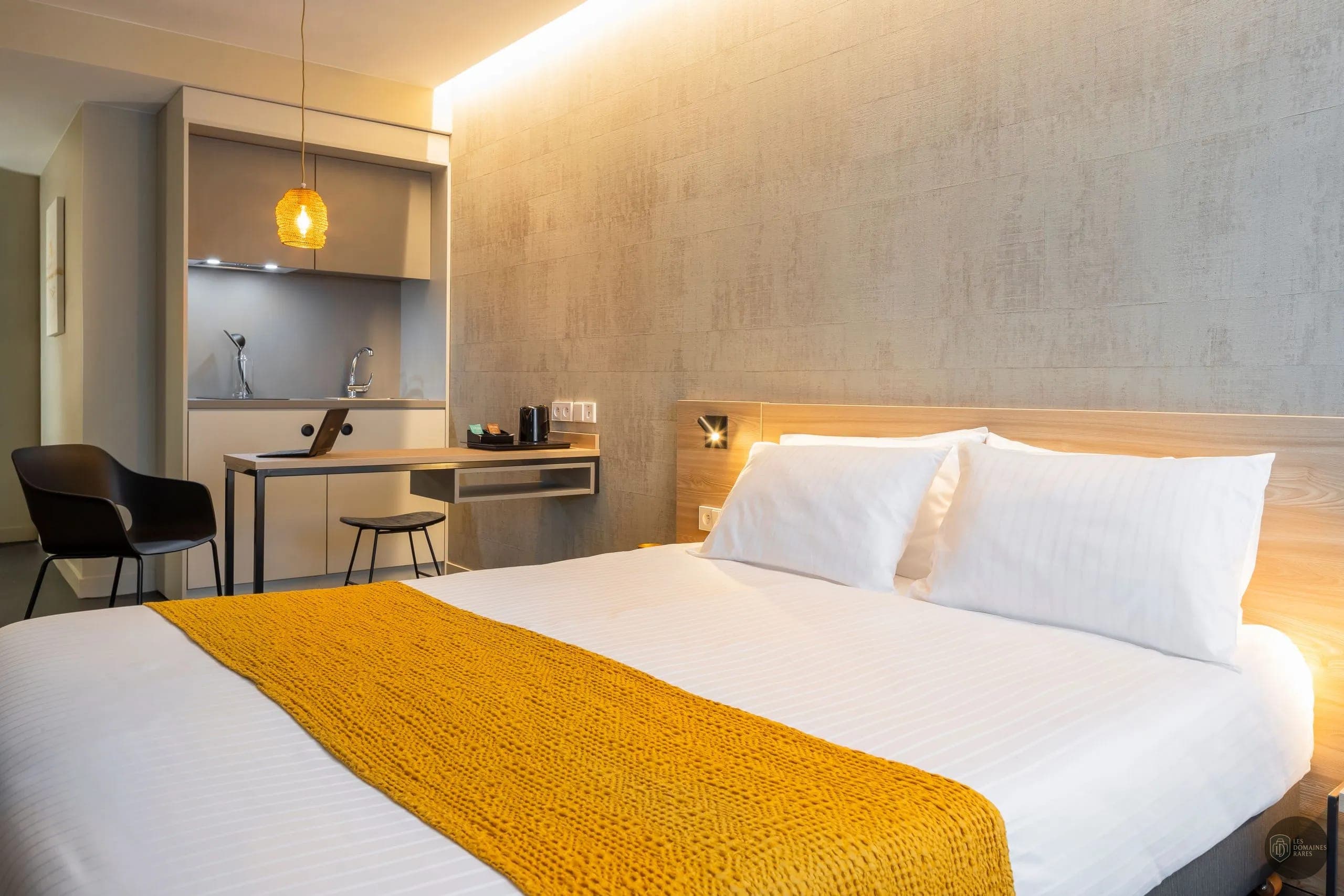 Chambre moderne avec lit double et kitchenette