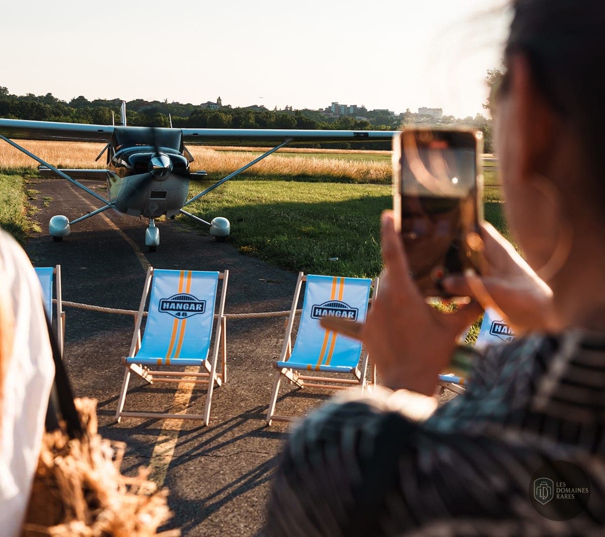 Avion sur piste et chaises longues
